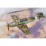 Static airplane model with green camouflage and orange nose, propeller plane