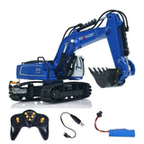 Blue 1/18 RC excavator model with front bucket, remote controller, and battery pack