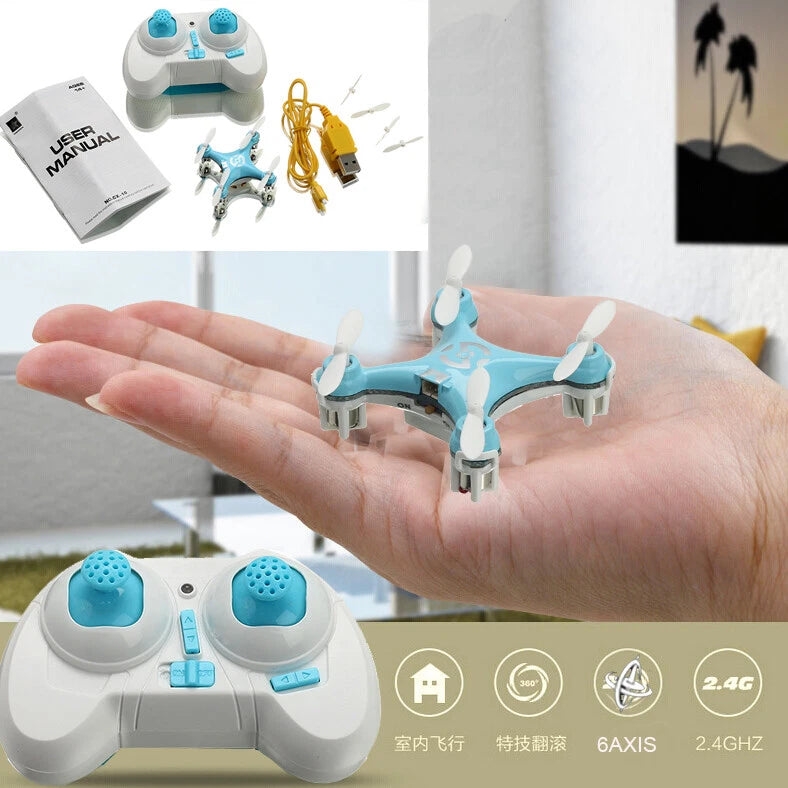 Blue mini quadcopter drone with four rotors held in hand, with white remote controller