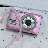Pink compact Nikon Coolpix digital camera with visible lens and side grip details