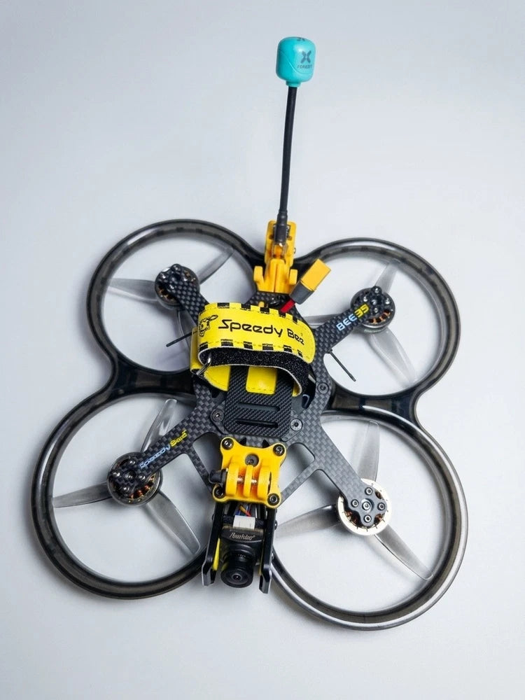 3.5 inch FPV cinewhoop drone with ducted props, yellow and gray body, teal antenna