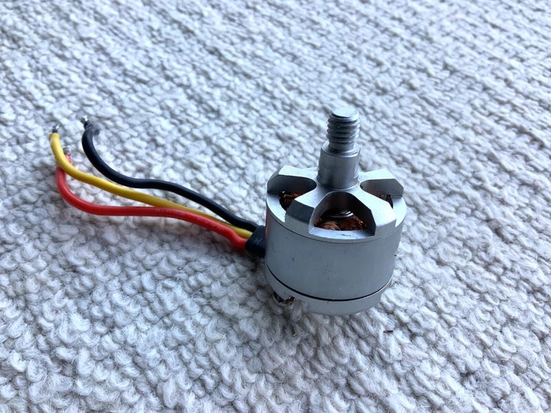 Counterclockwise drone motor with silver housing and multicolor wiring leads