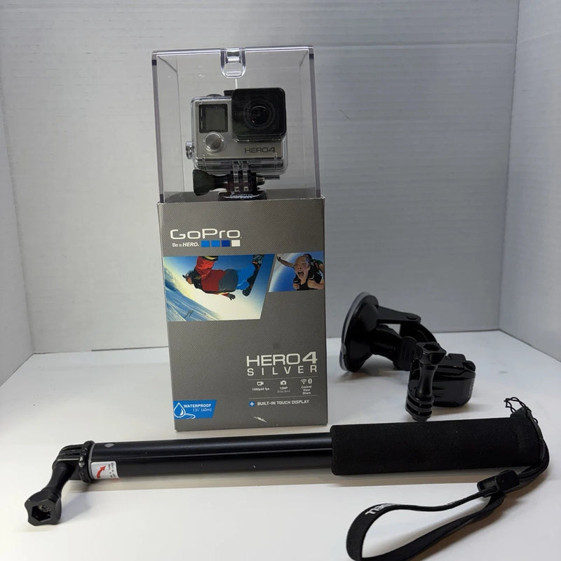 Silver action camera in clear box with mounting bar and wrist strap