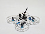 White FPV quadcopter drone with four propellers, camera module, and antenna