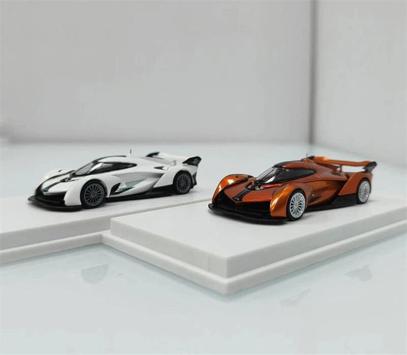 1:64 Solus GT model cars: white and metallic orange on a display shelf