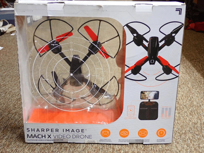 Video streaming quadcopter drone with camera, shown in retail box with propellers