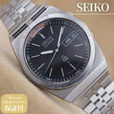 Seiko Quartz wristwatch with dark dial, baton markers, and metal bracelet
