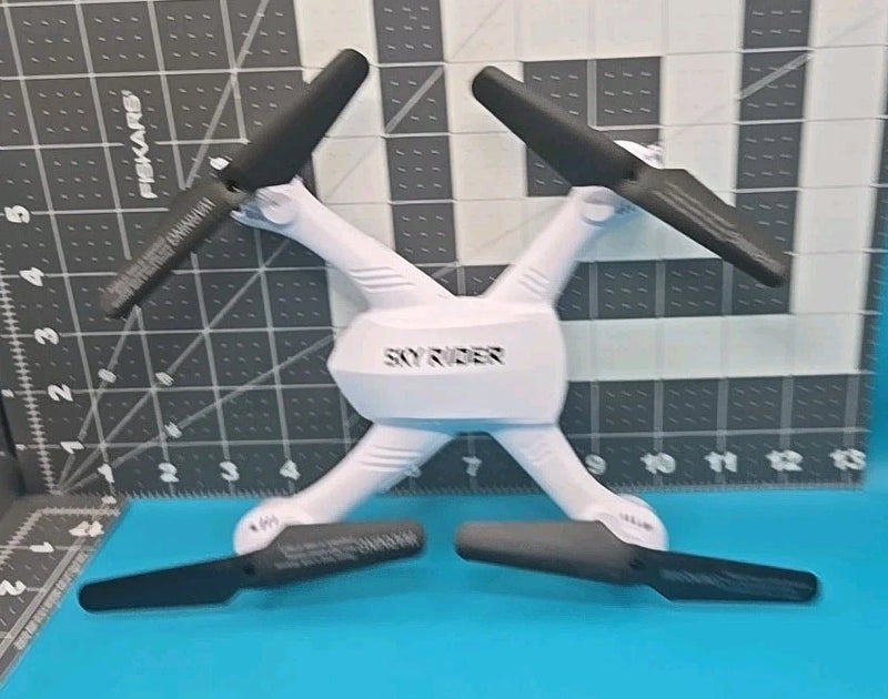 White quadcopter drone with four propellers, centered top view