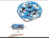 Blue and black mini UFO drone toy with propellers, hovering above a hand