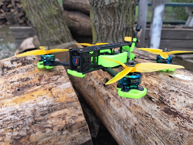 Green FPV quadcopter drone with TPU frame, propellers, and camera mount