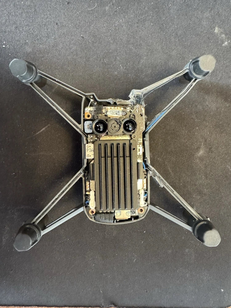 Quadcopter drone for parts with exposed circuit board and four arms