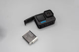 Black GoPro action camera with front lens, screen, and battery pack