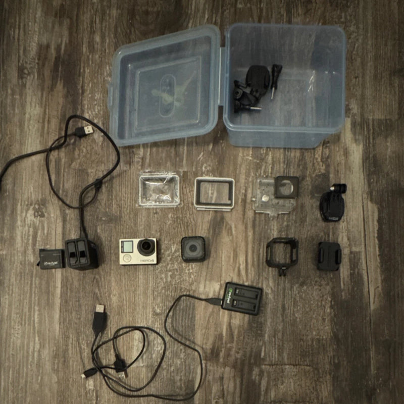 Action camera accessory bundle with camera, waterproof housing, mounts, cables and batteries