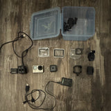 Action camera accessory bundle with camera, waterproof housing, mounts, cables and batteries
