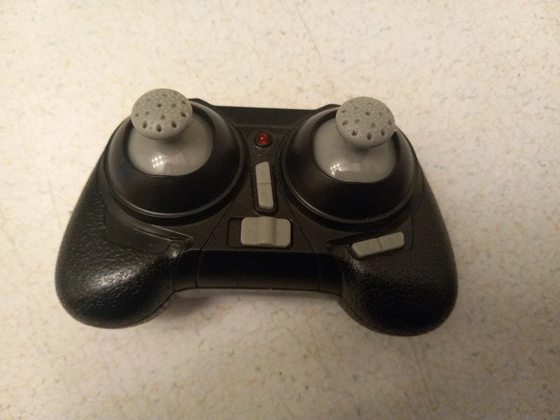 Black RC nano quadcopter remote control with two thumbsticks and buttons