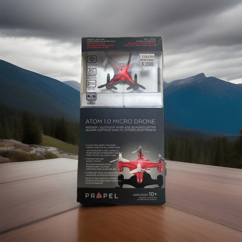 Red micro quadcopter drone in retail box packaging