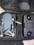 Foldable toy quadcopter drone and controller in open gray carry case