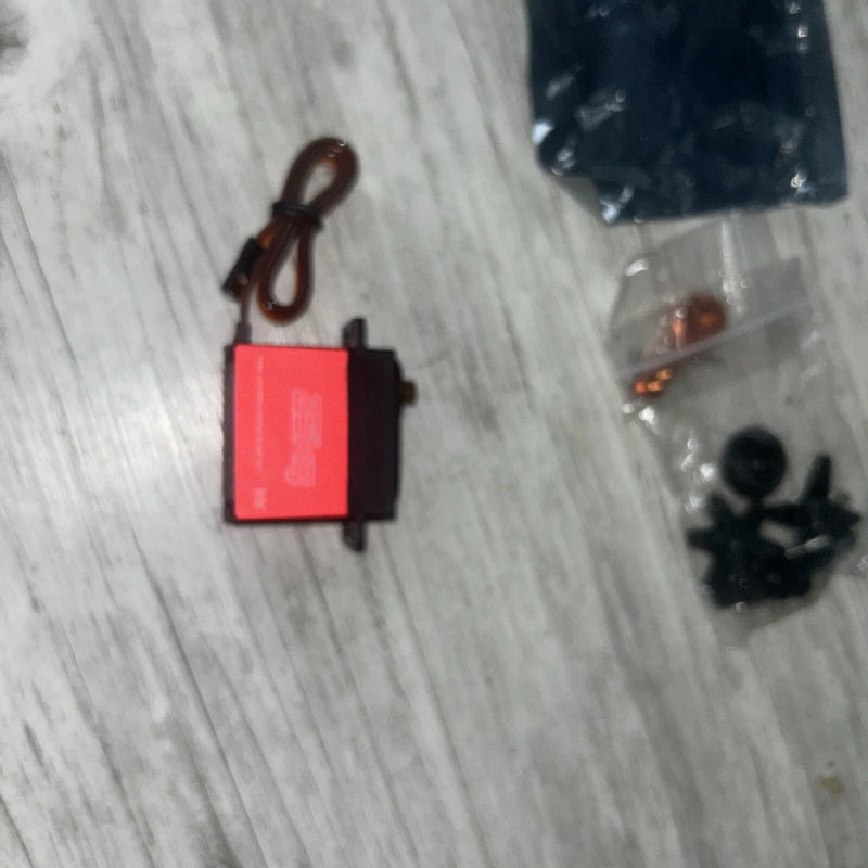 Red digital servo with attached lead wire and mounting interface