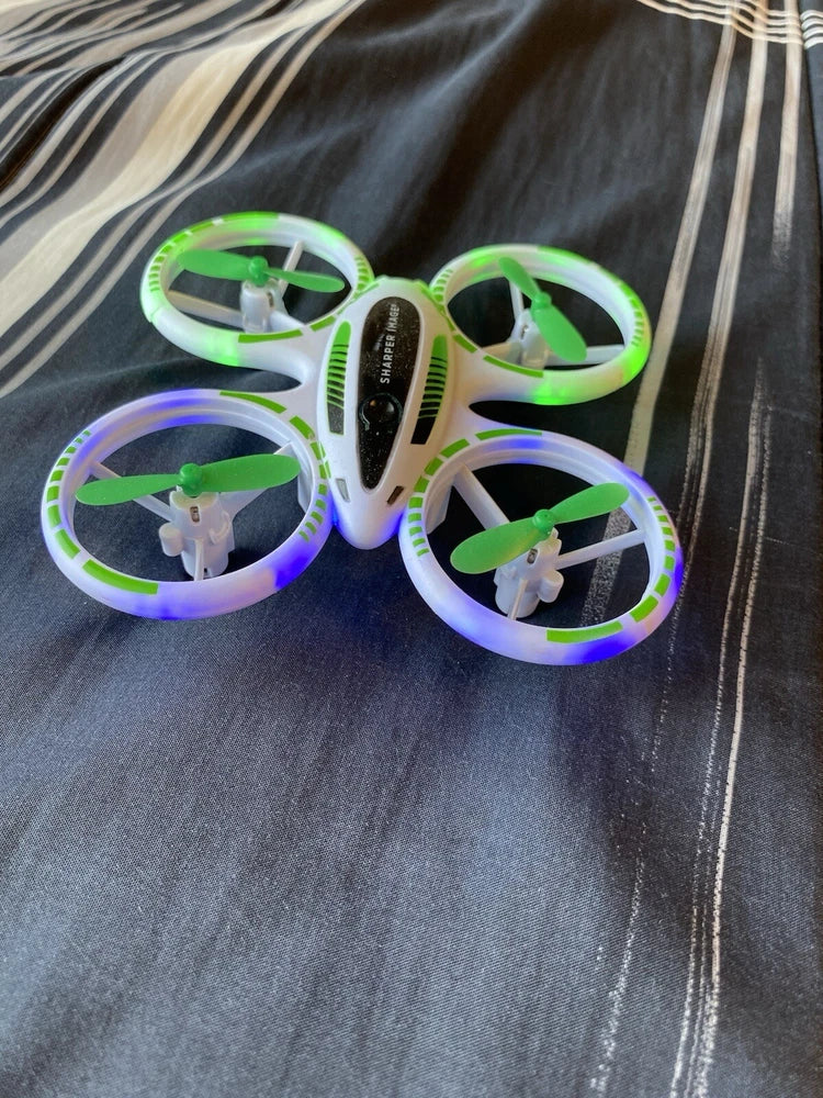 RC mini drone with four RGB LED ring propellers and green center body