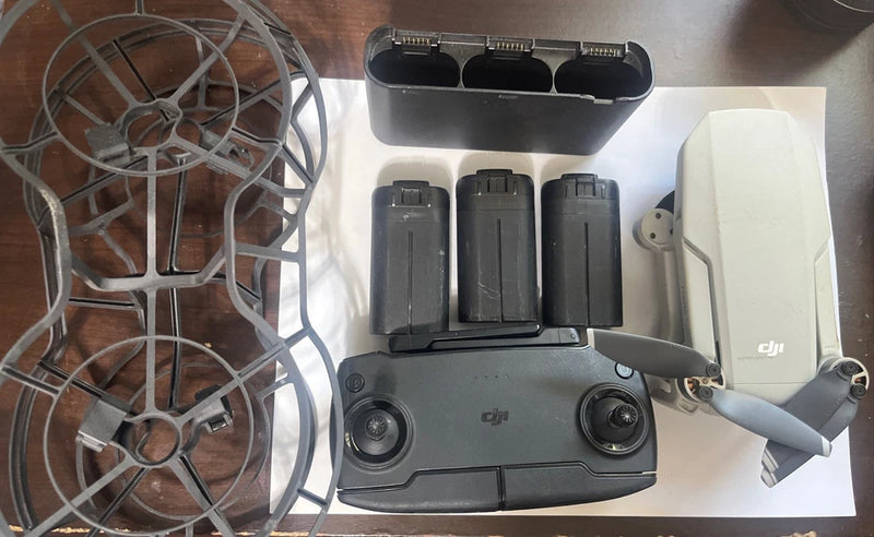 DJI drone controller and three batteries with charging dock