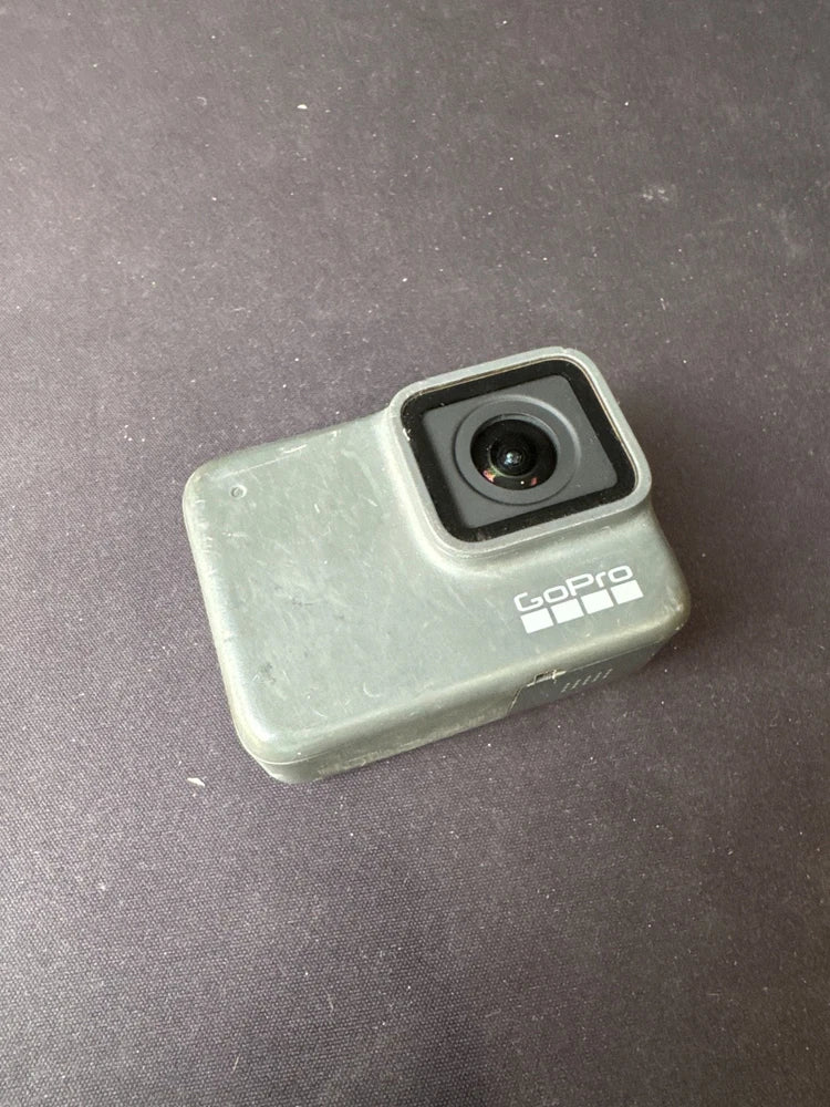 Silver GoPro action camera housing with lens and GoPro logo, for parts