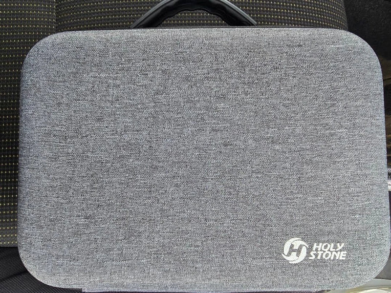 Gray fabric drone carrying case with rounded front and carry handle