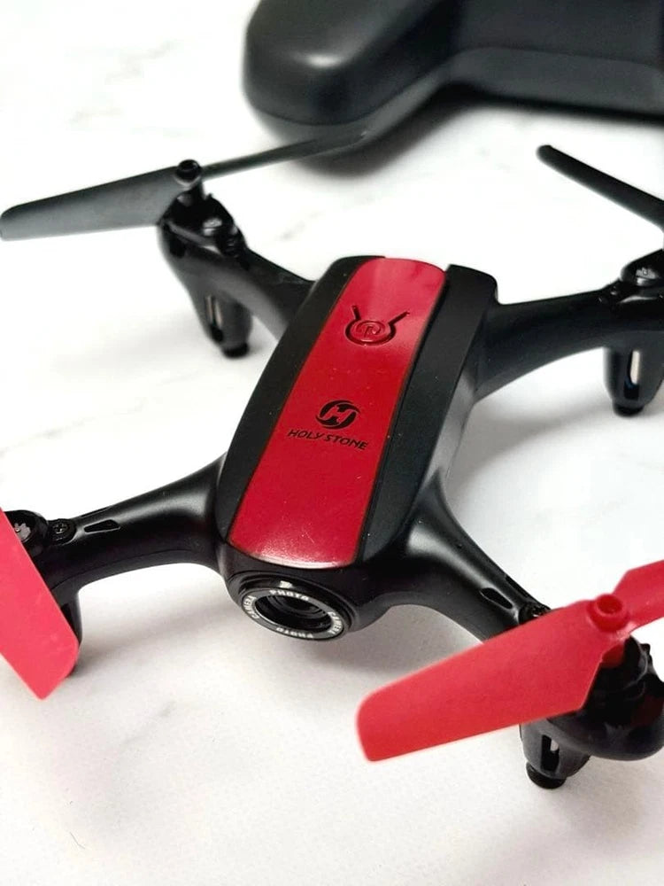 Red and black mini RC quadcopter drone with four propellers and camera