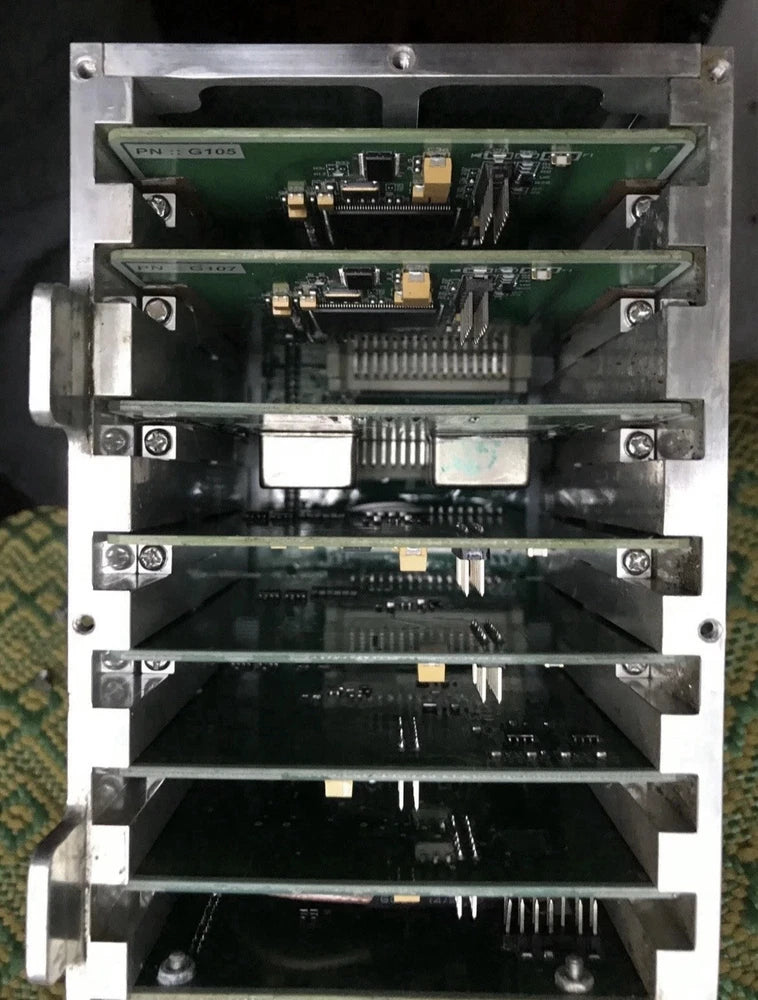 Electronic control box with exposed green circuit boards and ribbon connectors
