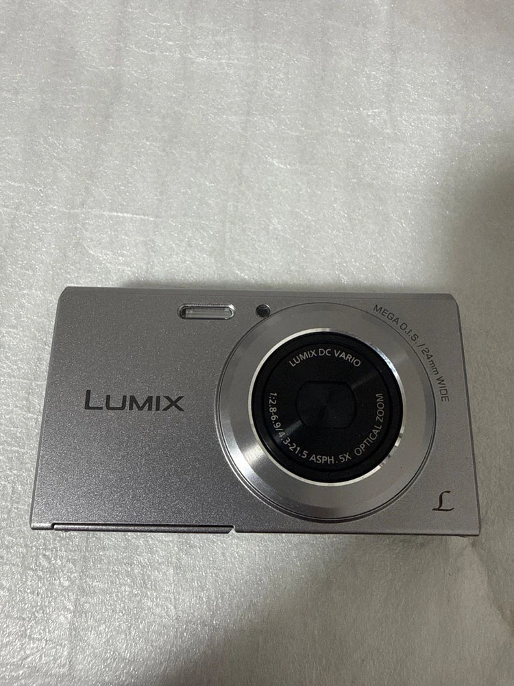 Panasonic Lumix compact digital camera with front lens and shutter button, dark gray
