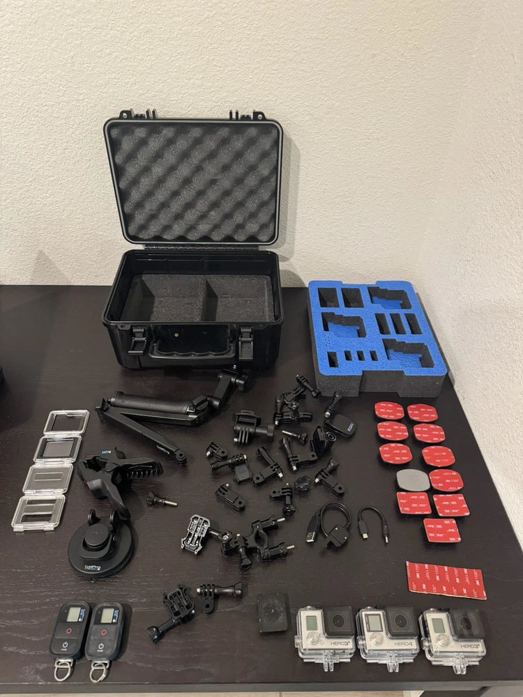 Action camera accessory bundle with open hard case, mounts, and remotes