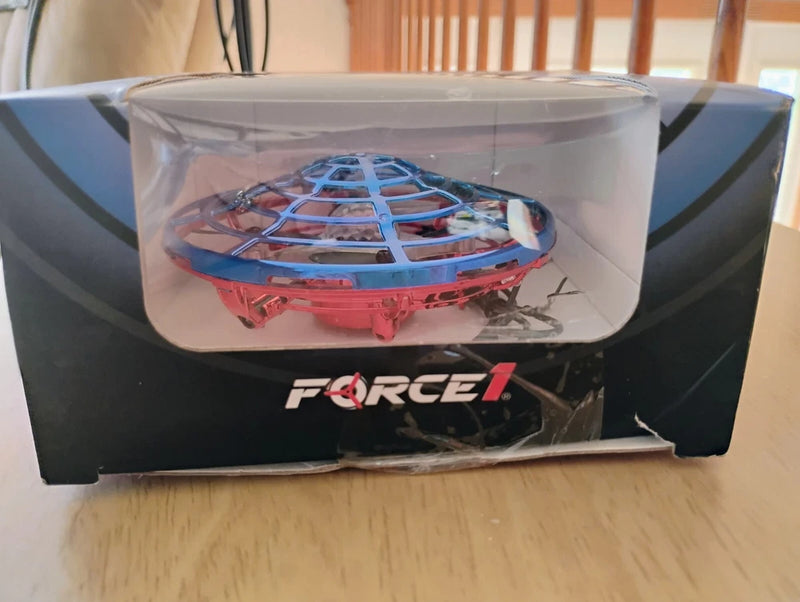 Blue indoor hand-operated drone inside retail box