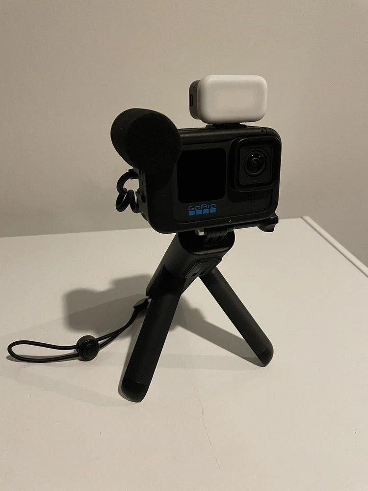 GoPro HERO11 Black action camera with microphone accessory and mini tripod