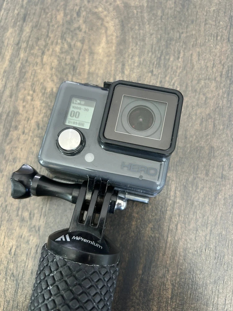 GoPro waterproof action camera in clear housing with touchscreen and wide lens, on mount