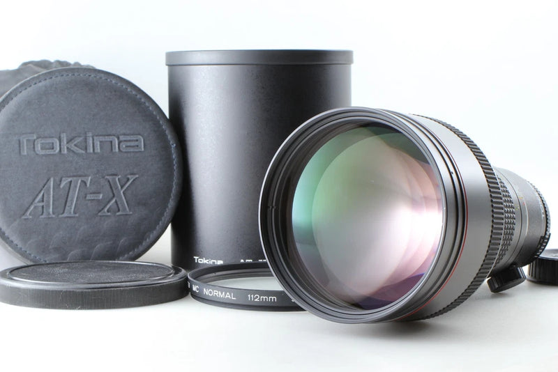 Tokina AT-X SD telephoto camera lens with hood and front/back caps, Nikon F mount