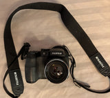 Fujifilm FinePix digital camera with black strap and front lens