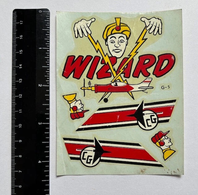 Vintage wizard-themed RC airplane decal with WIZARD text, red-and-white jets, lightning