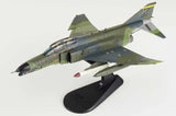 Green and gray camo F-4G Wild Weasel model airplane on display stand