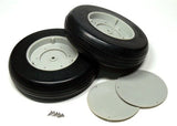 Pair of black rubber RC model airplane tires with white wheel hubs, plus screws and caps
