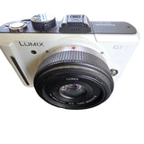 Panasonic LUMIX GF1 + F1.7 pancake lens Panasonic white with 3.5-5.6 Attached.