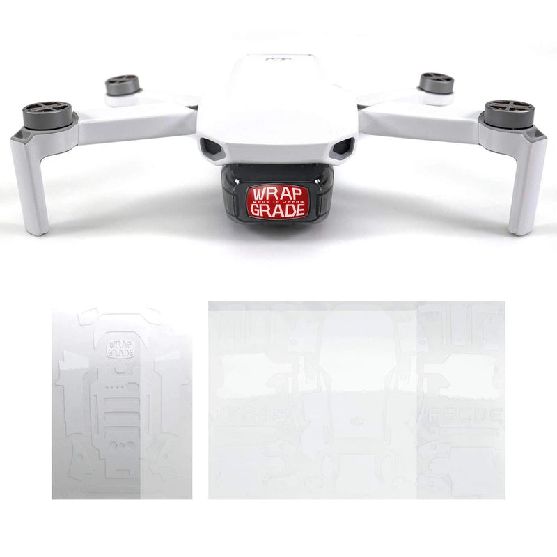 White quadcopter racing drone with four prop arms and WRAPGRADE logo on body