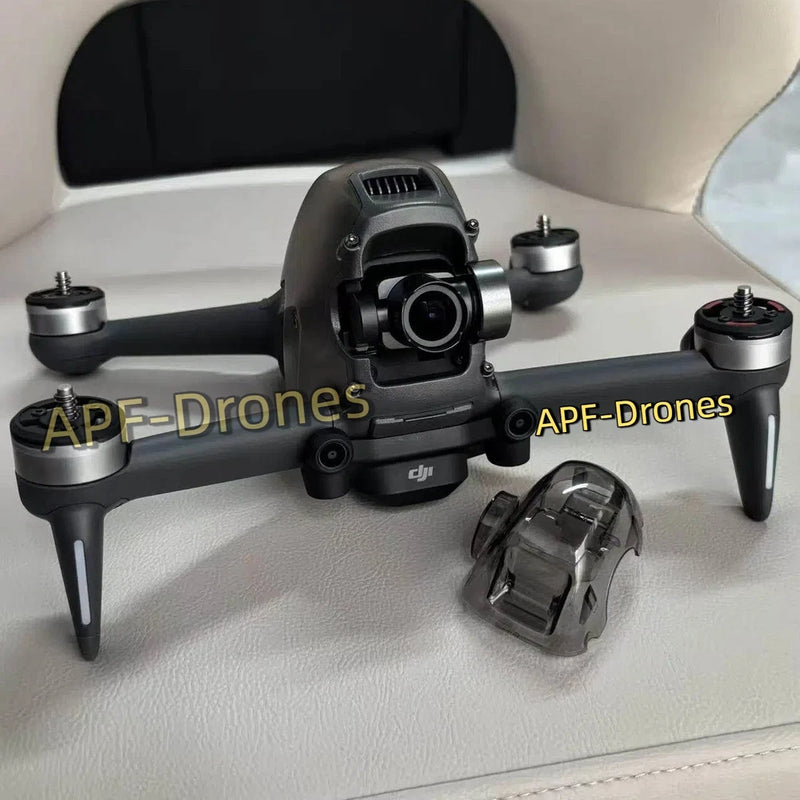 DJI FPV drone with front gimbal camera and propeller guards, plus detached prop holder