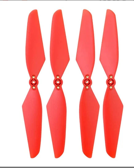 Four red-orange drone propeller blades with mounting hubs
