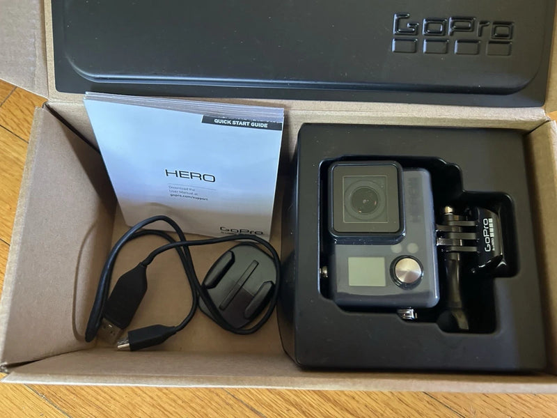 GoPro HERO mountable action camera in open box with accessories and cable