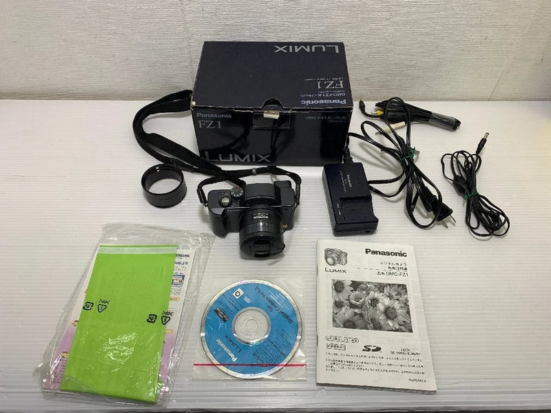 Panasonic LUMIX digital camera kit with lens, cables, charger, manuals, strap