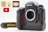 Black Nikon F5 35mm SLR film camera body with lens mount and strap