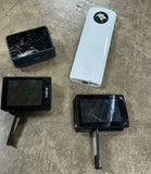 Action camera parts lot with LCD screens and white housing, black and white