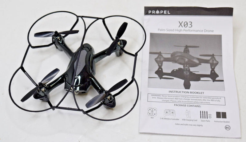 Palm-size micro quadcopter drone with four propellers, black and gray.