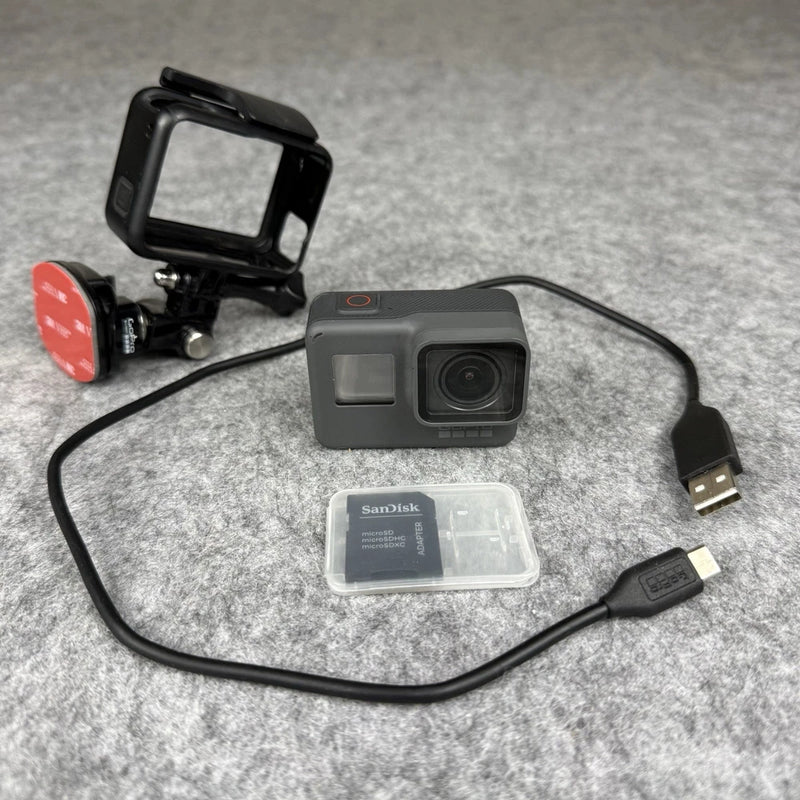 GoPro HERO5 action camera with housing, cables, and SanDisk memory card