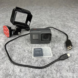 GoPro HERO5 action camera with housing, cables, and SanDisk memory card