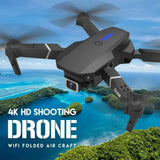 Foldable black quadcopter drone with front camera and four rotors